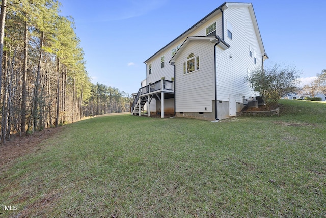 rear view of house featuring a yard and a wooden deck