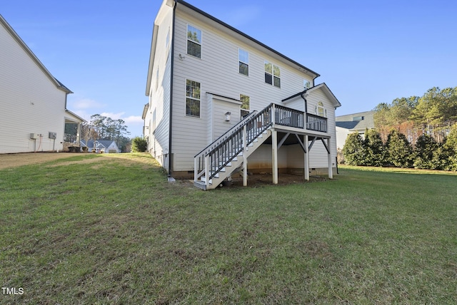 back of property with a deck and a lawn