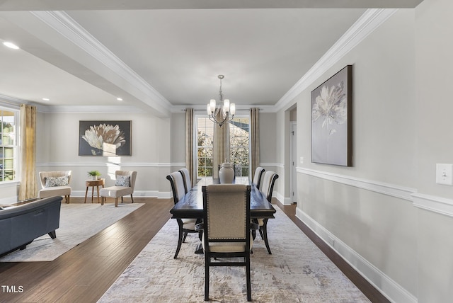 dining space with ornamental molding, a chandelier, and dark hardwood / wood-style flooring