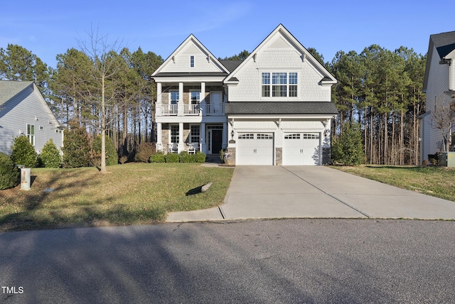 view of front facade featuring a balcony, a front lawn, and a garage