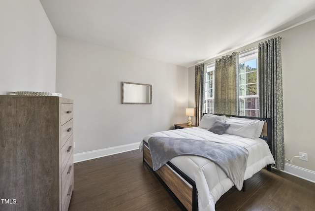 bedroom with dark wood-type flooring