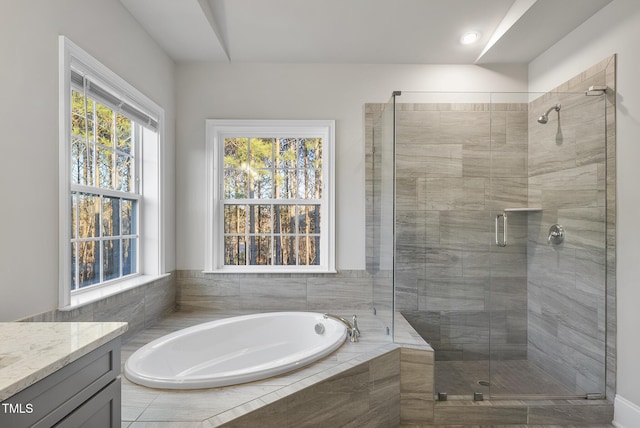 bathroom with vanity and separate shower and tub