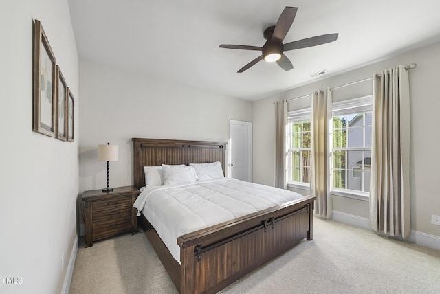 bedroom with ceiling fan and light carpet