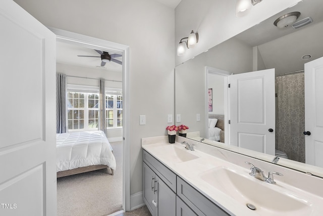 bathroom featuring ceiling fan, vanity, and toilet