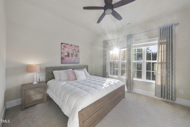 bedroom featuring lofted ceiling, light carpet, and ceiling fan