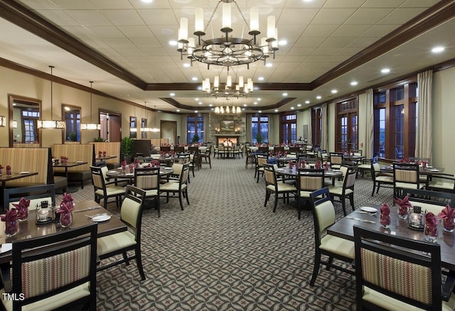 carpeted dining room featuring crown molding, an inviting chandelier, and a raised ceiling