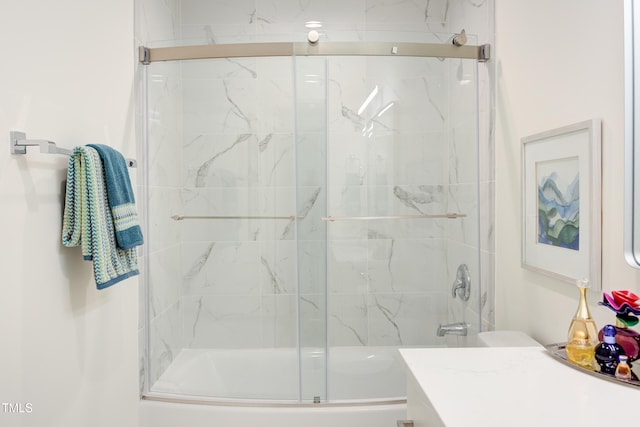 bathroom featuring vanity and combined bath / shower with glass door