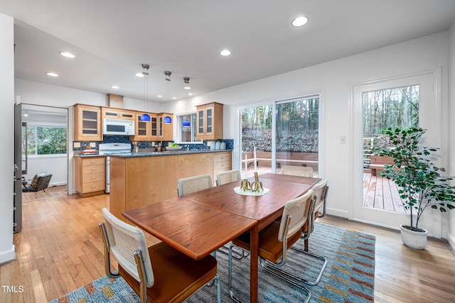 dining space featuring a wealth of natural light and light wood-type flooring