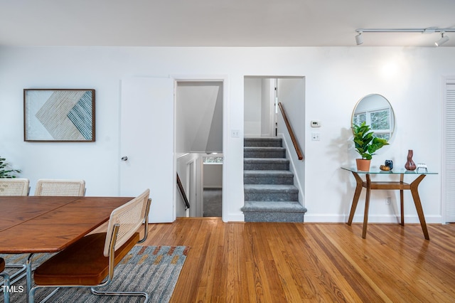 interior space with hardwood / wood-style floors and rail lighting