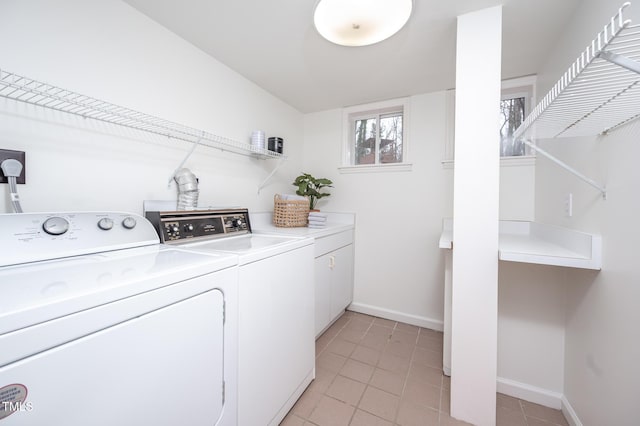 laundry room featuring light tile patterned flooring, cabinets, and separate washer and dryer