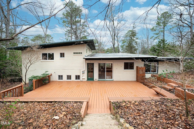 rear view of property with a wooden deck