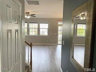 interior space with wood-type flooring and ceiling fan