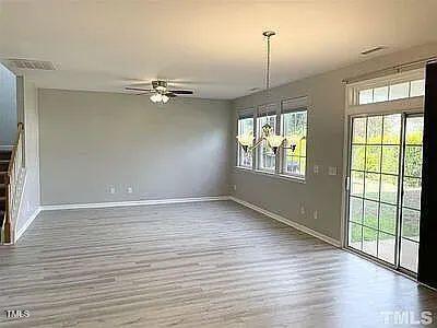 unfurnished dining area featuring ceiling fan and wood-type flooring