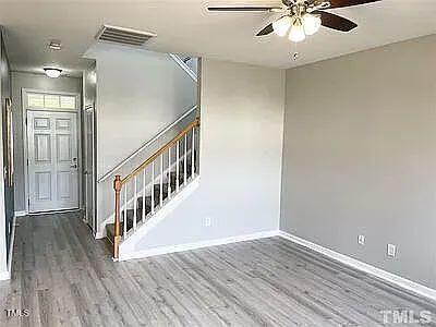 spare room with ceiling fan and dark hardwood / wood-style flooring