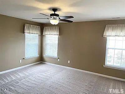 carpeted empty room with ceiling fan