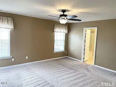 unfurnished room featuring carpet and ceiling fan