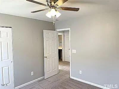 unfurnished bedroom featuring carpet flooring and ceiling fan