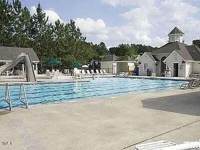 view of pool featuring a patio area and a water slide