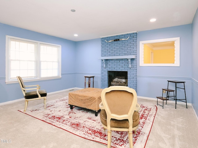 sitting room featuring carpet and a fireplace