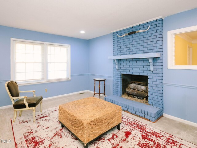 living area with a fireplace and carpet flooring