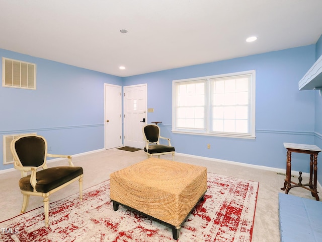 living area with light colored carpet