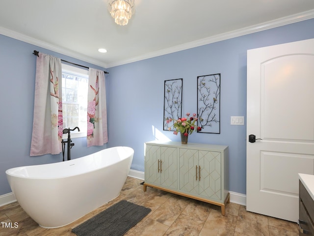 bathroom with a bathtub, crown molding, and vanity