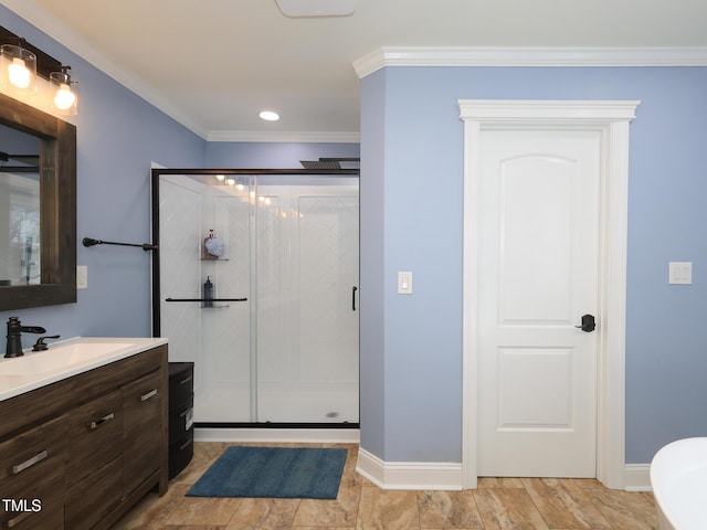 bathroom featuring vanity, a shower with shower door, and crown molding