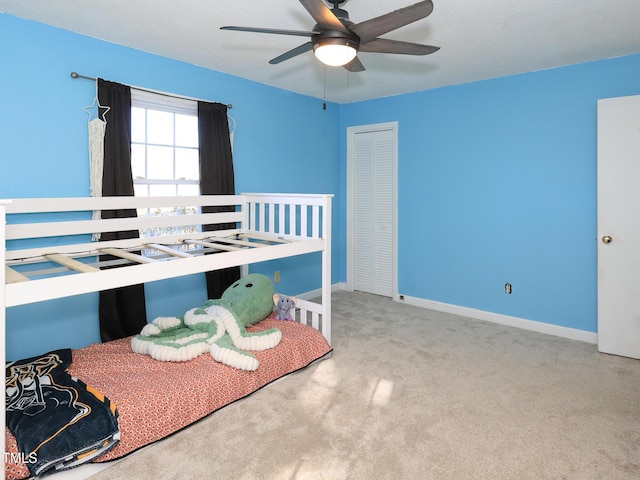 unfurnished bedroom featuring ceiling fan, a closet, and light colored carpet