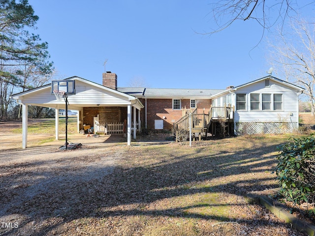 back of house with a carport