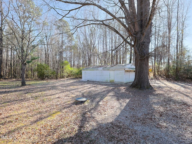 view of yard with a garage and an outdoor structure