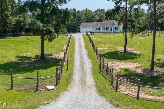 view of community with a yard and a rural view