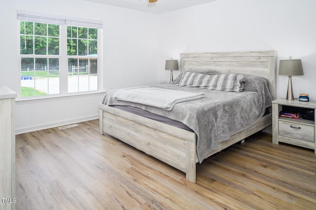 bedroom with wood-type flooring