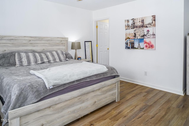 bedroom with hardwood / wood-style flooring