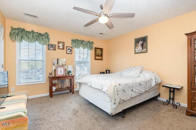 bedroom with carpet floors, visible vents, and baseboards