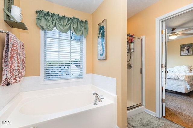 bathroom featuring a stall shower, ensuite bath, a ceiling fan, and a bath