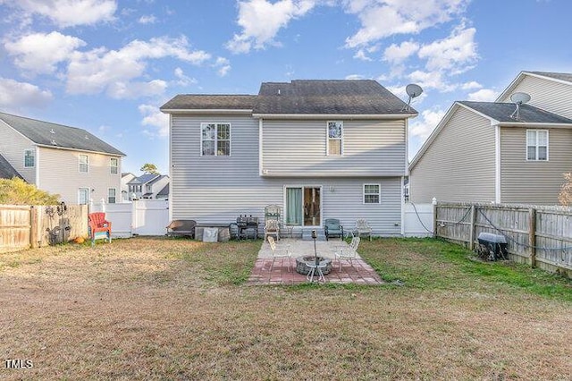 rear view of house with a patio area, a fenced backyard, and a lawn