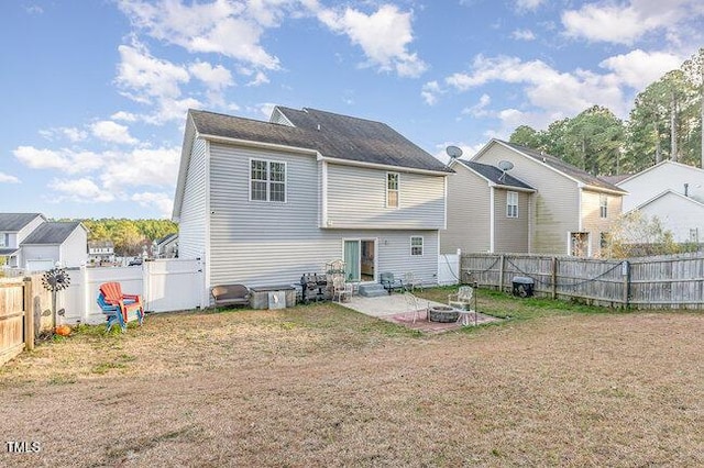 back of house featuring a lawn, a patio area, and a fenced backyard