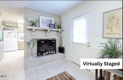 interior space with crown molding and a fireplace