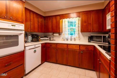 kitchen featuring white appliances and sink