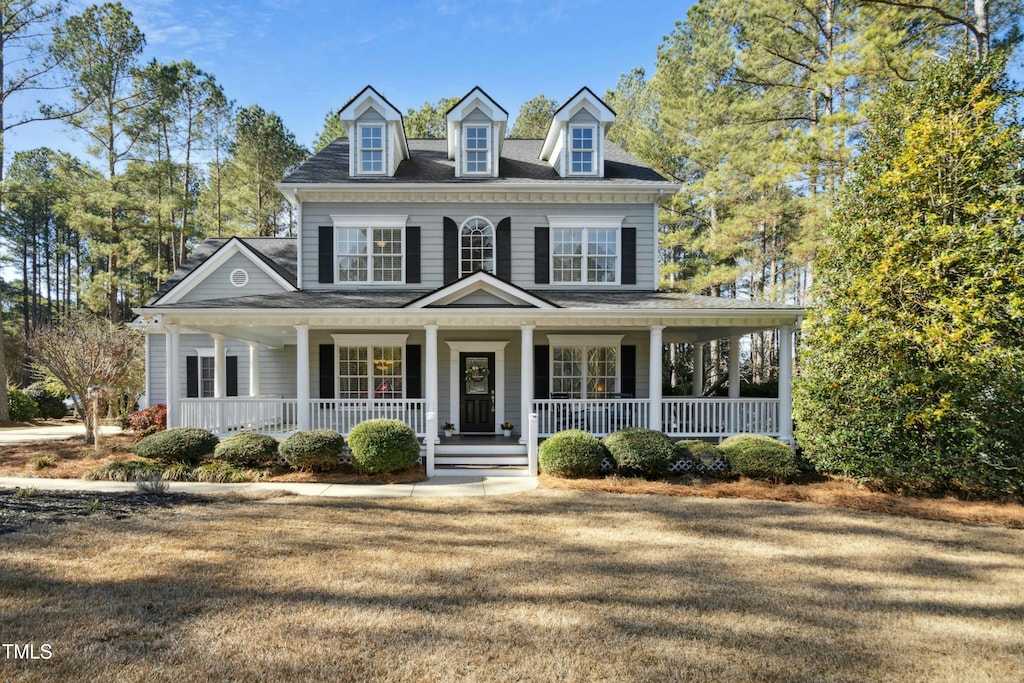 view of front of home with a front yard and covered porch