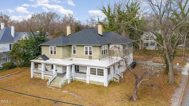 rear view of house featuring a porch