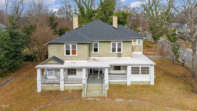 view of front of home with covered porch and a front yard