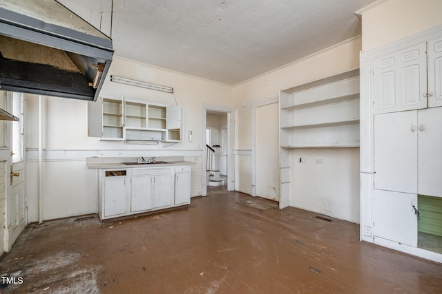 kitchen with dark hardwood / wood-style floors, white cabinetry, and sink