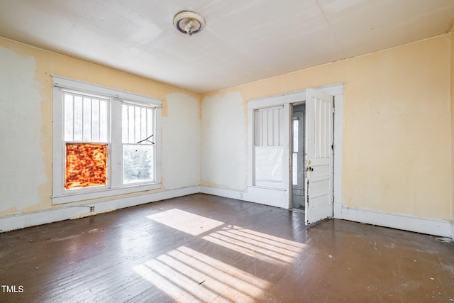 unfurnished room featuring dark wood-type flooring