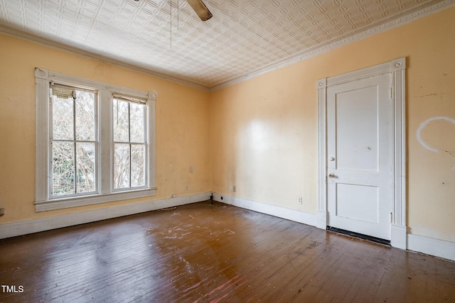 empty room featuring dark hardwood / wood-style floors, ceiling fan, and ornamental molding