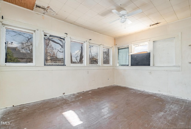 empty room with ceiling fan and dark wood-type flooring