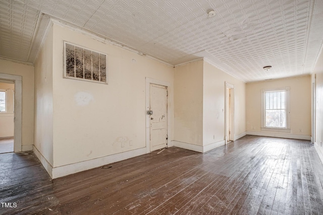 interior space with ornamental molding and dark wood-type flooring