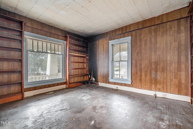 empty room featuring wooden walls