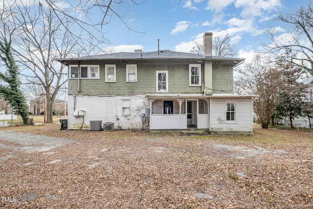 back of house with covered porch and central AC