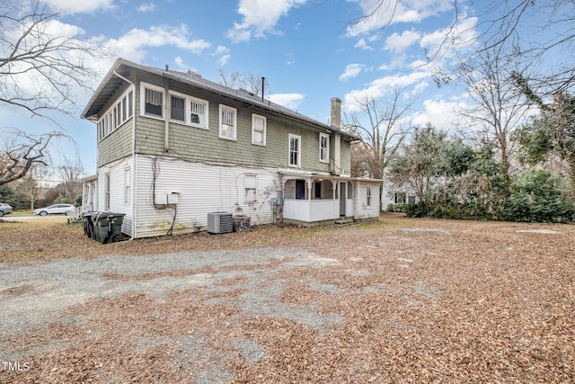 rear view of house featuring central AC unit